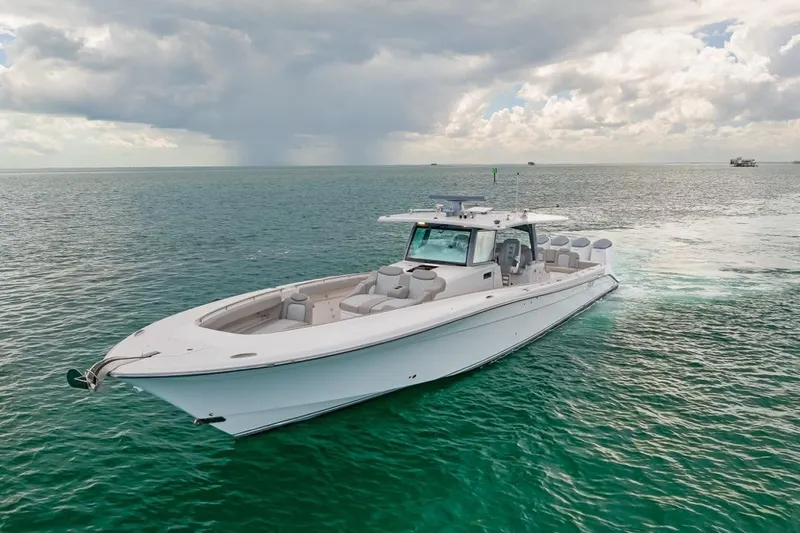  Yacht Photos Pics 2023 HCB 53 Sueños boat cruising on open sea under cloudy sky.