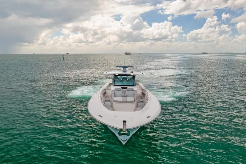 Yacht Photos Pics 2023 HCB 53 Sueños boat cruising on open water under a cloudy sky.