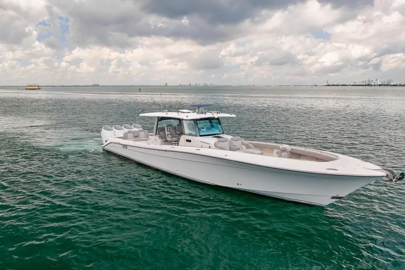  Yacht Photos Pics 2023 HCB 53 Sueños luxury boat cruising on open water under cloudy skies.