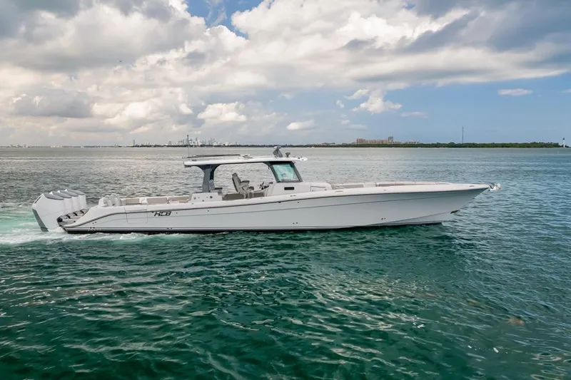  Yacht Photos Pics 2023 HCB 53 Sueños boat cruising on open water under a cloudy sky.