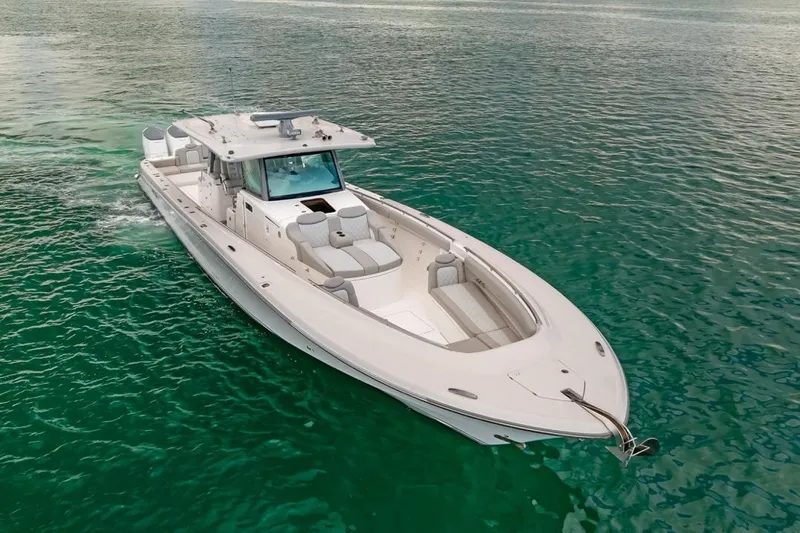  Yacht Photos Pics 2023 HCB 53 Sueños boat cruising on clear turquoise water.