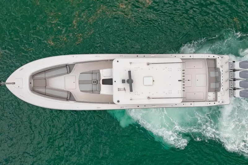  Yacht Photos Pics Aerial view of 2023 HCB 53 Sueños boat cruising on green water.