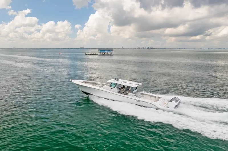  Yacht Photos Pics 2023 HCB 53 Sueños boat cruising on open water under cloudy sky.