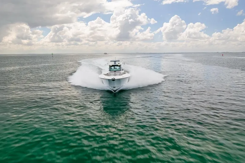  Yacht Photos Pics 2023 HCB 53 Sueños boat cruising on open water under cloudy sky.