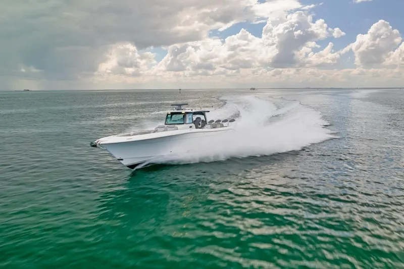  Yacht Photos Pics 2023 HCB 53 Sueños boat cruising on open water under cloudy sky.