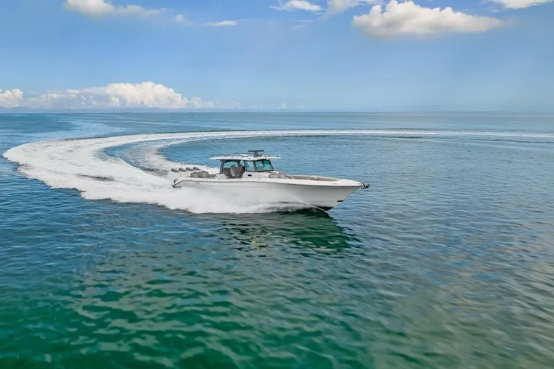  Yacht Photos Pics 2023 HCB 53 Sueños boat cruising on open water under blue sky.