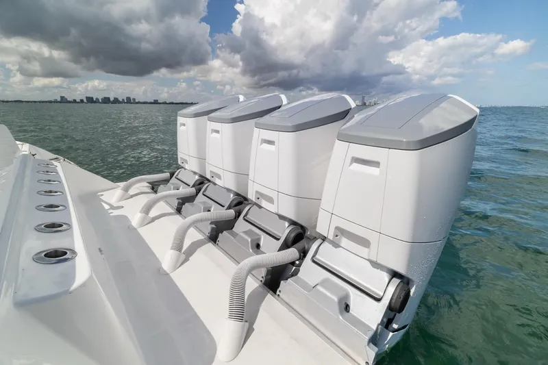  Yacht Photos Pics 2023 HCB 53 Sueños boat with four powerful outboard engines on open water.