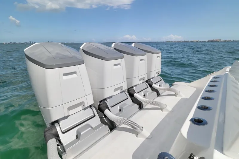  Yacht Photos Pics Four powerful outboard engines on a 2023 HCB 53 Sueños boat in open water.