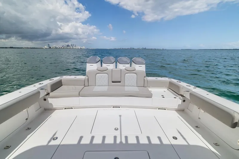  Yacht Photos Pics 2023 HCB 53 Sueños boat deck with ocean view and city skyline.