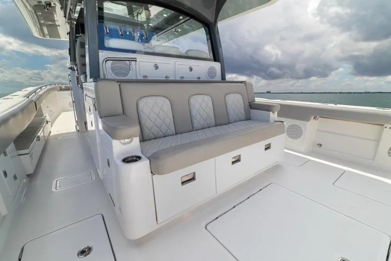  Yacht Photos Pics 2023 HCB 53 Sueños luxury boat interior with cushioned seating and ocean view.
