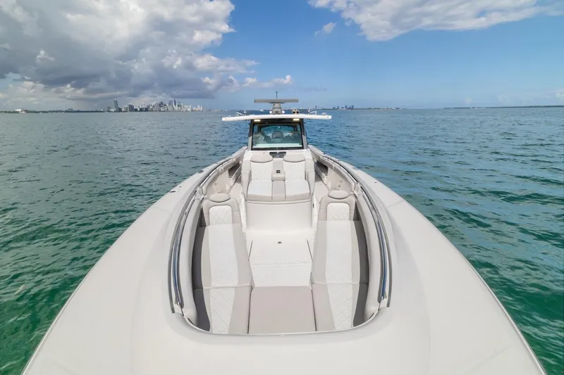  Yacht Photos Pics 2023 HCB 53 Sueños luxury boat on open water with city skyline.