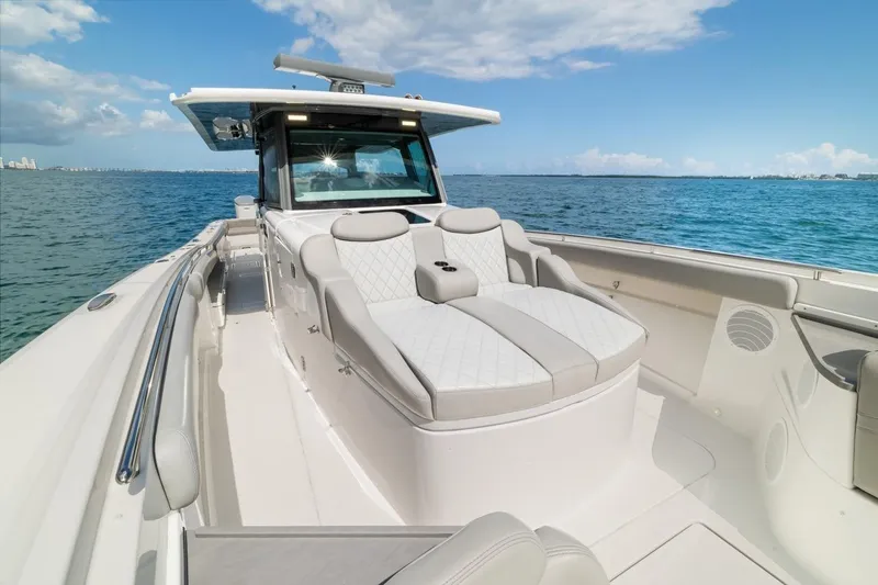  Yacht Photos Pics Luxury 2023 HCB 53 Sueños boat with elegant seating on open water.