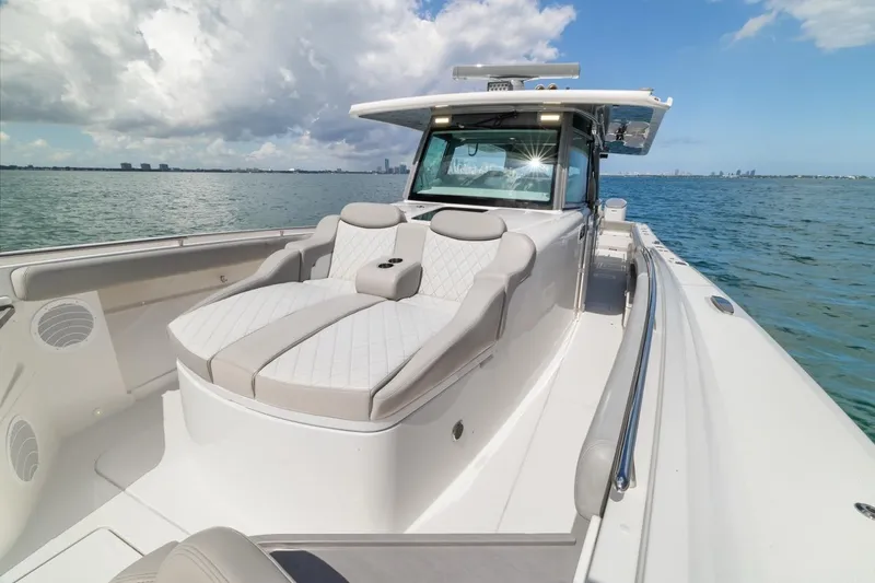 Yacht Photos Pics 2023 HCB 53 Sueños luxury boat on calm waters under a partly cloudy sky.