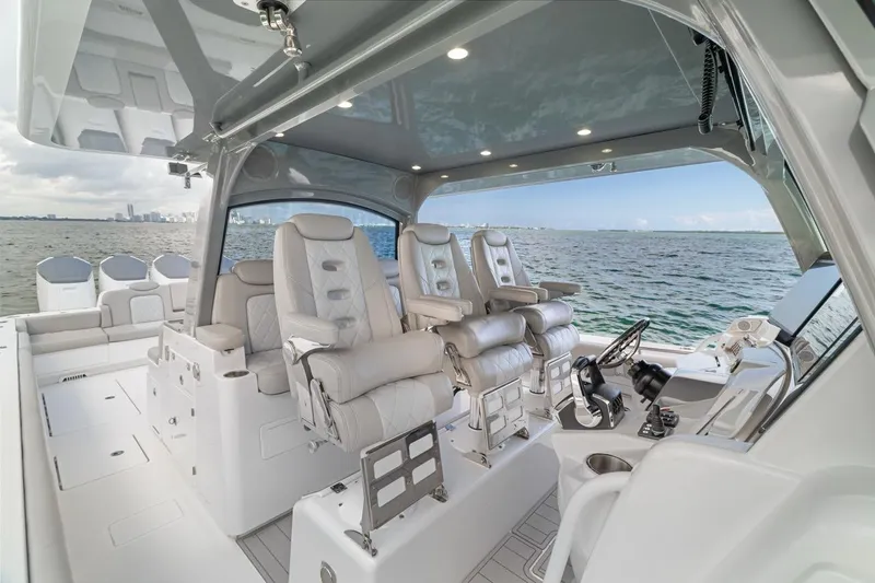  Yacht Photos Pics Luxurious interior of 2023 HCB 53 Sueños boat with plush seating and modern controls.