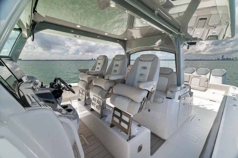  Yacht Photos Pics Luxurious interior of 2023 HCB 53 Sueños boat with plush seating and modern helm.