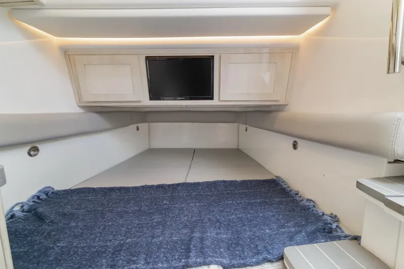  Yacht Photos Pics 2023 HCB 53 Sueños cabin interior with TV and blue rug.