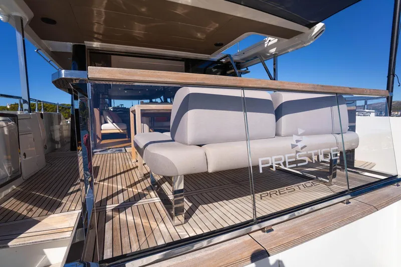 Leena Yacht Photos Pics 2023 Prestige X60 yacht deck with modern seating and glass railing.