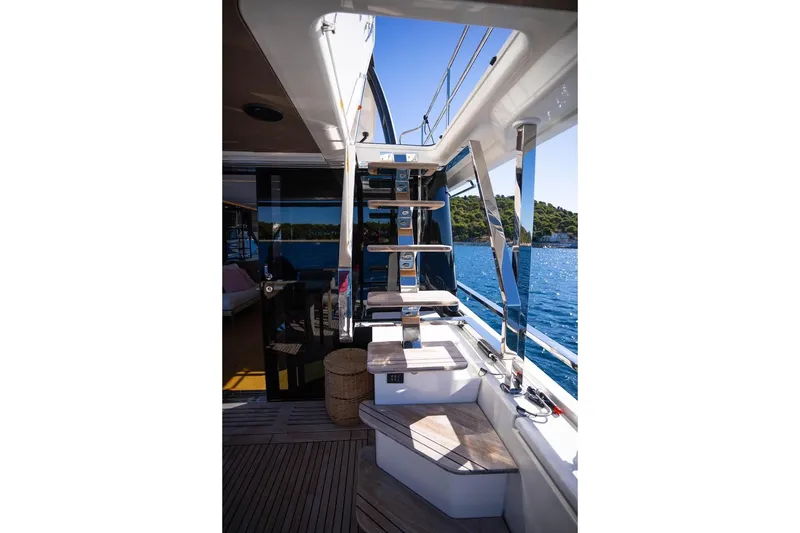 Leena Yacht Photos Pics Luxurious 2023 Prestige X60 yacht interior with sleek staircase and ocean view.