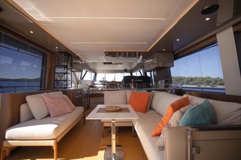Leena Yacht Photos Pics Luxurious interior of 2023 Prestige X60 yacht with modern seating and panoramic windows.