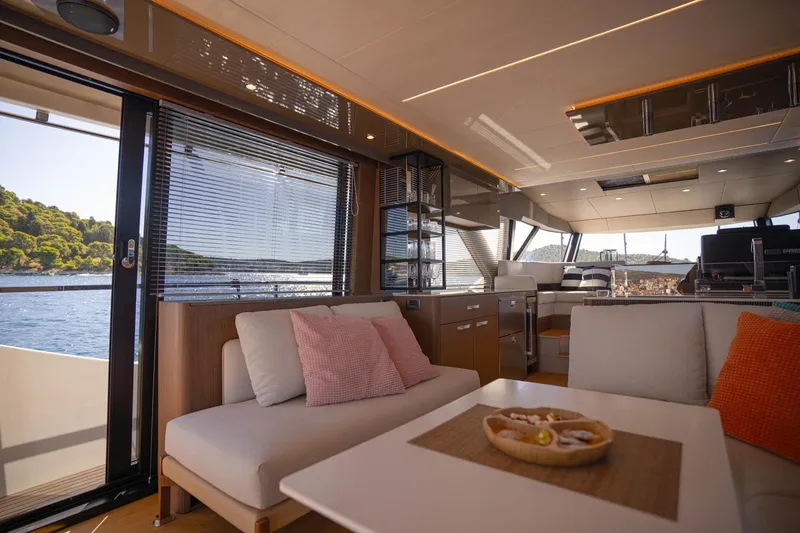 Leena Yacht Photos Pics Luxurious interior of 2023 Prestige X60 yacht with modern furnishings and scenic ocean view.
