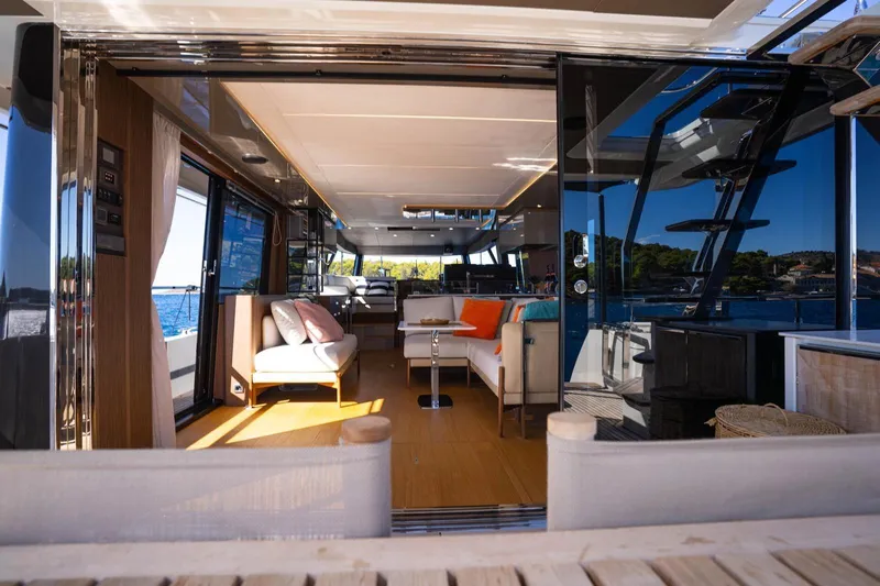 Leena Yacht Photos Pics Luxurious interior of 2023 Prestige X60 yacht with modern furnishings and ocean view.