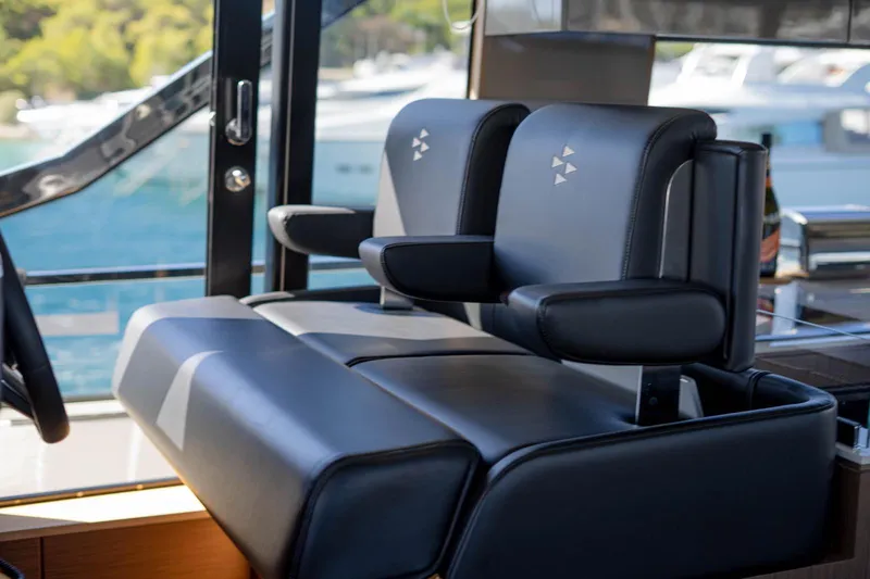 Leena Yacht Photos Pics Luxury seating on 2023 Prestige X60 yacht, featuring sleek black leather design.