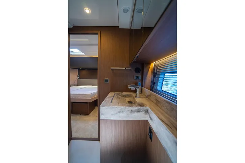 Leena Yacht Photos Pics Luxurious interior of 2023 Prestige X60 yacht featuring modern bathroom and bedroom.
