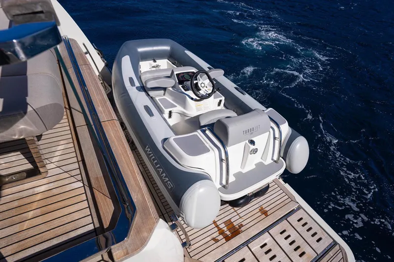 Leena Yacht Photos Pics 2023 Prestige X60 yacht with Williams Turbojet tender on deck, ocean backdrop.