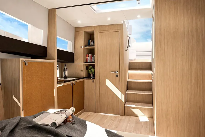  Yacht Photos Pics Modern interior of 2026 Fjord 490 OPEN yacht with wooden cabinetry and stairs.