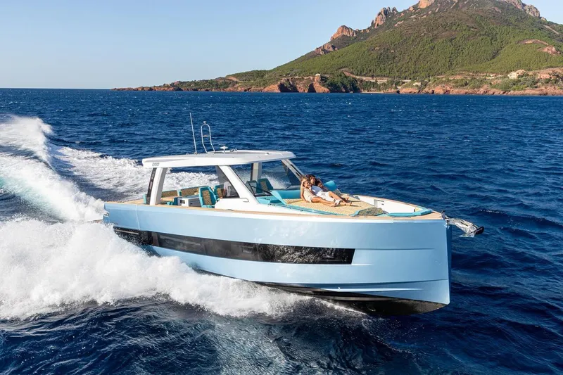  Yacht Photos Pics 2026 Fjord 490 OPEN yacht cruising on blue ocean near scenic coastline.