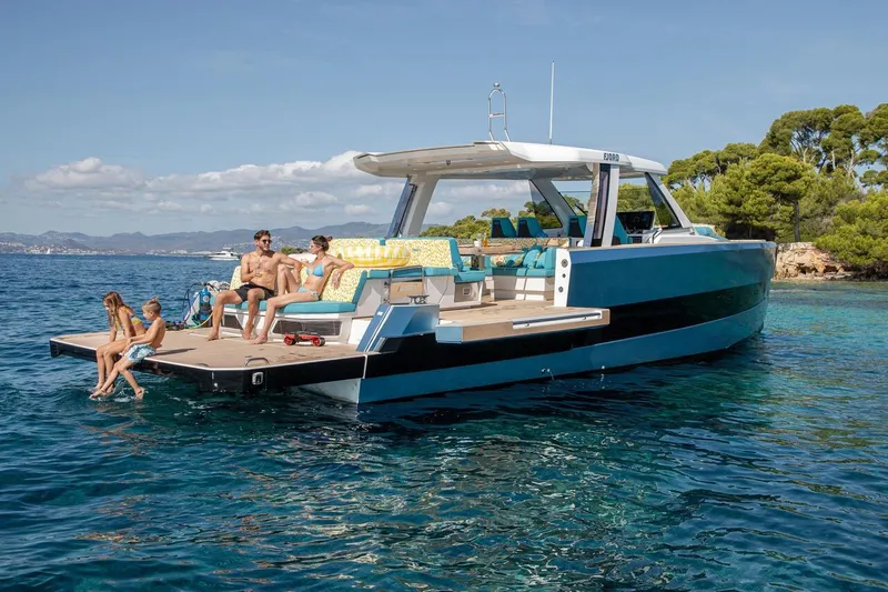  Yacht Photos Pics 2026 Fjord 490 OPEN yacht with people relaxing on deck in scenic waters.