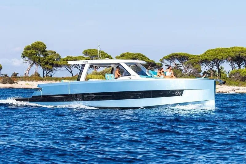  Yacht Photos Pics Fjord 490 OPEN 2026 cruising on blue waters near a scenic coastline.