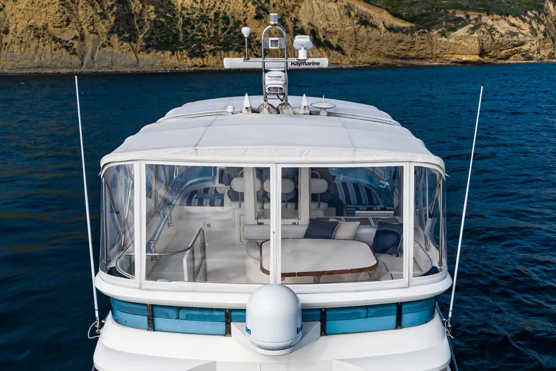 Desperado Yacht Photos Pics 2002 Fairline Squadron 58 yacht on water, featuring spacious deck and clear enclosure.