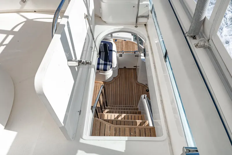 Desperado Yacht Photos Pics Staircase on 2002 Fairline Squadron 58 yacht with wooden steps and seating area.