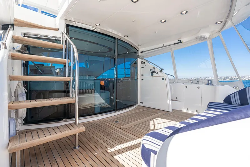 Desperado Yacht Photos Pics Luxurious 2002 Fairline Squadron 58 yacht interior with wooden deck and modern seating.