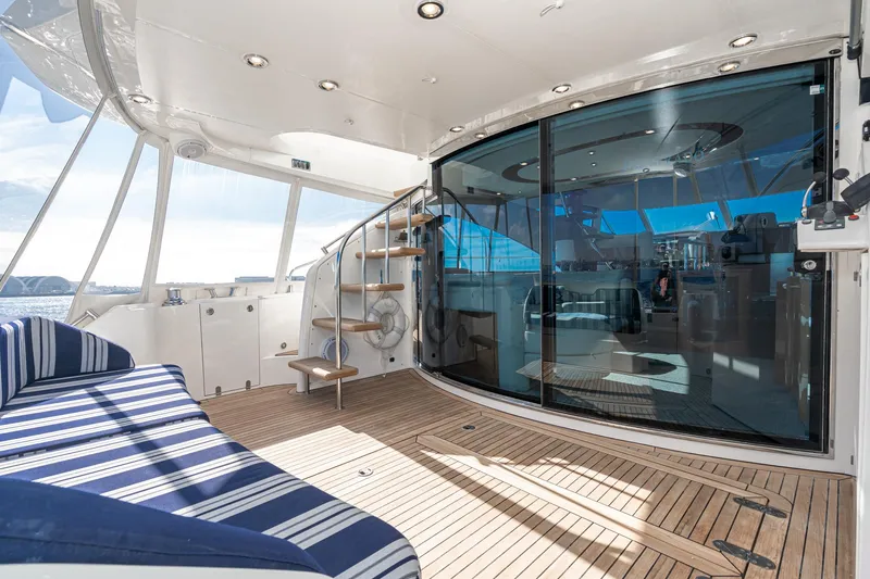 Desperado Yacht Photos Pics Luxurious 2002 Fairline Squadron 58 yacht interior with striped seating and wooden deck.