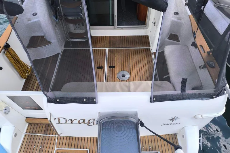  Yacht Photos Pics 2009 Jeanneau Merry Fischer 925 boat deck with seating and wooden flooring.