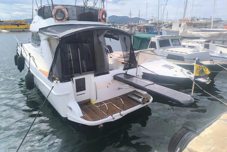  Yacht Photos Pics 2009 Jeanneau Merry Fischer 925 docked at a marina, rear view.