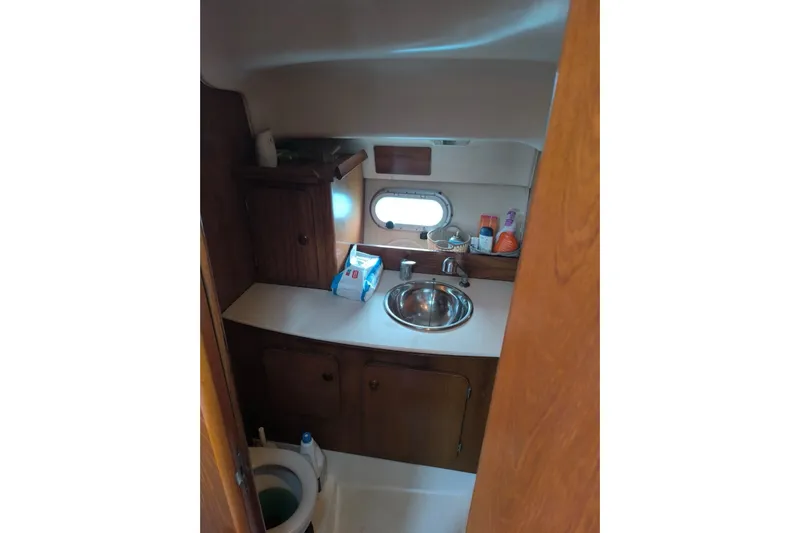  Yacht Photos Pics 2009 Jeanneau Merry Fischer 925 bathroom with sink, toilet, and storage cabinets.