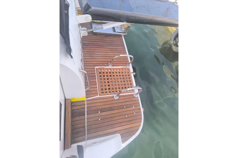  Yacht Photos Pics 2009 Jeanneau Merry Fischer 925 swim platform with wooden deck and ladder.