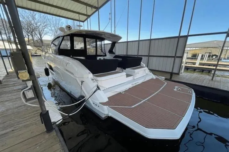  Yacht Photos Pics 2018 Cruisers Yachts 390 Express Coupe docked in a covered marina.