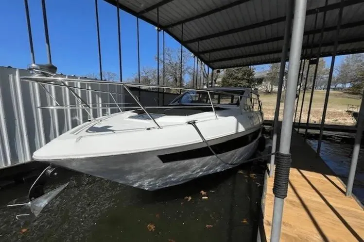  Yacht Photos Pics 2018 Cruisers Yachts 390 Express Coupe docked under a covered marina.