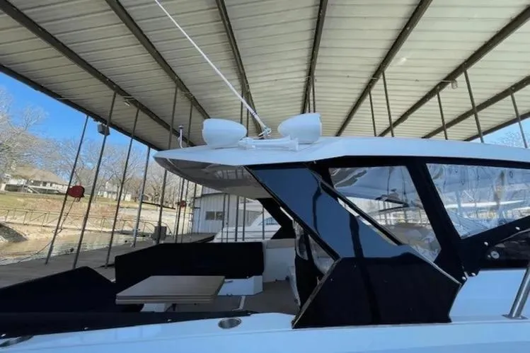 Yacht Photos Pics 2018 Cruisers Yachts 390 Express Coupe docked under a covered marina.