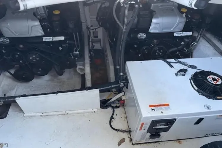  Yacht Photos Pics Engine compartment of 2018 Cruisers Yachts 390 Express Coupe with visible machinery and components.