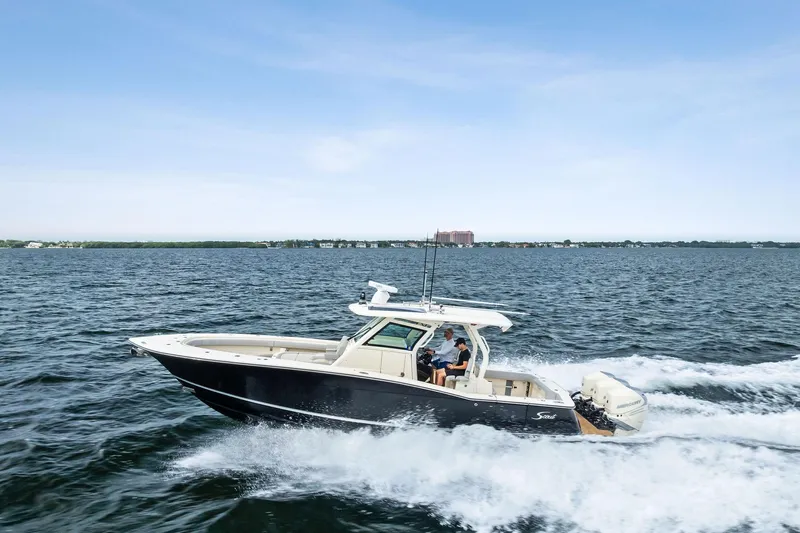 Prime Tyme Yacht Photos Pics 2020 Scout 355 LXF boat cruising on open water under a clear sky.