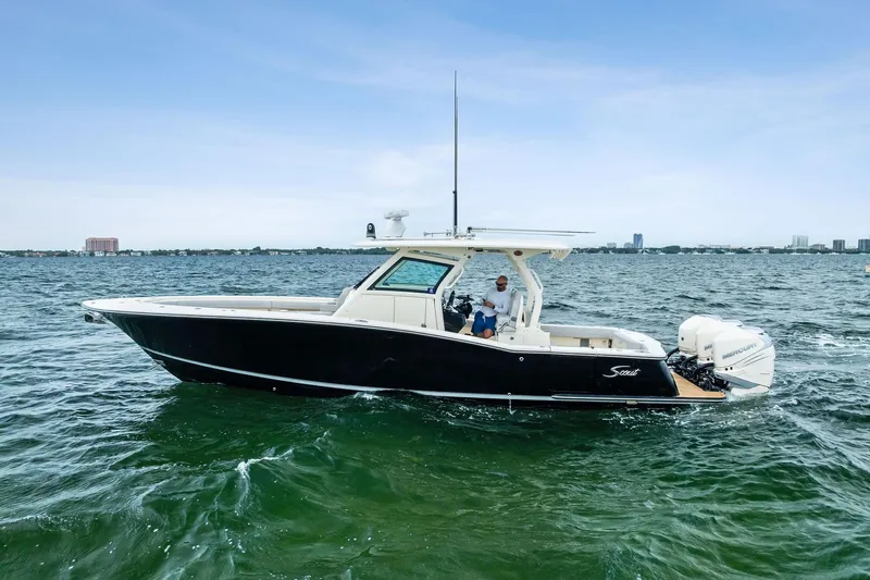 Prime Tyme Yacht Photos Pics 2020 Scout 355 LXF boat cruising on open water under clear skies.