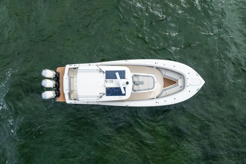 Prime Tyme Yacht Photos Pics Aerial view of 2020 Scout 355 LXF boat on green water.