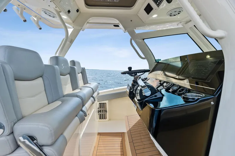 Prime Tyme Yacht Photos Pics 2020 Scout 355 LXF boat interior with modern helm and seating, ocean view.