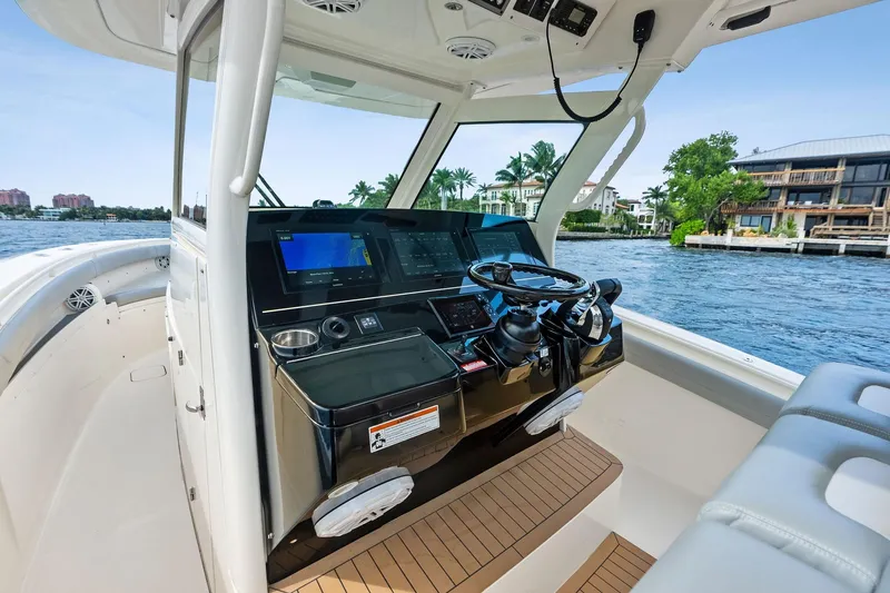 Prime Tyme Yacht Photos Pics 2020 Scout 355 LXF boat helm with modern controls and waterfront view.