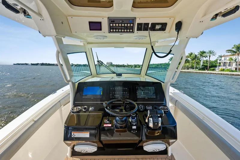 Prime Tyme Yacht Photos Pics 2020 Scout 355 LXF boat helm with advanced navigation system on open water.